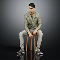 Man Sitting on Wooden Stool Wearing Light Green Blazer Gray Pants and Gray Shoes