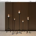 Multiple Black Metal Candle Lamps In Different Heights With Dark Wooden Wall And Light Carpet