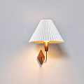 Wall Lamp With White Pleated Shade Wooden Base And Warm Illumination On Light Wall
