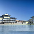 Aerial Planning of Complex With Connected Structures Blue Rooftops Green Lawns Waterfront and Mountain Views