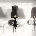 Modern Black and Silver Wall Lamps with Fabric Shades Mounted on White Wall