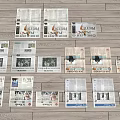 Various Magazines Spread Out On Wooden Floor With Different Covers And Colorful