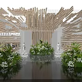 Contemporary Exhibition Display With Wooden Stick Structure Green Plants White Flowers Models And Water Reflection