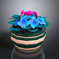 Potted Plant With Pink And Blue Flowers Green Leaves In Striped Pot