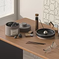Decorative Ornament Set With Black Stones Gray Cylindrical Box And Silver Ball On Wooden Tabletop