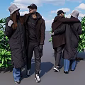 Two People Interacting And Hugging In Coats With Hats Near Green Plants And Blue Sky