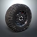 Black Off Road Tire With Deep Tread Pattern And Metal Rim Design
