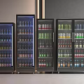 Black Upright Beverage Refrigerators Filled With Various Colorful Drinks Arranged Together