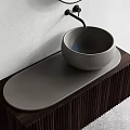 Modern Bowl Washbasin Design With Oval Dark Wooden Countertop And Black Faucet On Light Wall