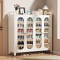 White Shoe Cabinet With Glass Doors Multiple Shelves And Decorative Items On Top
