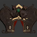 Dark Colored Carved Decorative Sculpture With Demon Figures Holding Green Object And Small Human Statues
