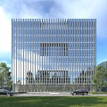 Modern Glass Curtain Wall Office Building With Vertical Facade Front Lawn And Trees