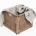 Brown Woven Storage Basket with Gray Towel Inside and Overhanging Design