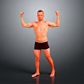 Shirtless Man in Black Shorts Raising Arms to Showcase Muscles on Gray Background