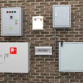 Industrial Electrical Control Panels Mounted on Brick Wall with Safety Features
