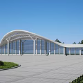 Modern Station Architectural Design With Curved Roof Glass Walls Spacious Plaza And Surrounding Greenery