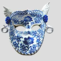 Blue And White Ceramic Mask With Intricate Floral Patterns And Ornate Decorations
