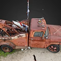 Rusty Old Tow Truck With American Flags On Dirt Ground And Grass