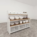 Black Kitchen Storage Shelf With White Bowls Mugs Brown Containers And Metal Mesh Baskets