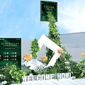 Interior Floral Art Installation With Green Plants Yellow Flowers Decorative Frames And Welcome Signage