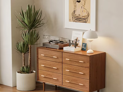 Wooden Storage Cabinet with Drawers and Metal Handles in Room with Green Plant and Lamp 3d model