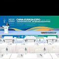 China Eurasia Expo Conference Venue With Podium Backdrop Tables Chairs And Water Bottles