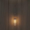 Modern Minimalist Wall Lamp With Glass Shade Emitting Warm Glow On Wooden Wall