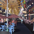 Vibrant Night Commercial Street With Street Lamps Neon Lights Outdoor Seating And Shop Signs