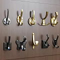 Various Design Wall Hooks in Gold and Black Colors on Wooden Wall