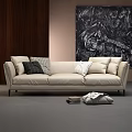 Beige Three-Seater Sofa with Decorative Pillows Dark Wooden Wall Black White Art Books and Blanket