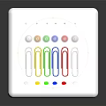White Organizer with Colorful Push Pins and Paper Clips on