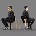 Man In Black Sweatshirt Pants And Sneakers Sitting On Chair
