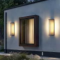 Modern Vertical Stripes Wall Light with Black Frame and Warm Illumination on White Wall