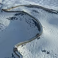 Snow Covered Great Wall With Winding Stone Path In Mountainous Winter Landscape