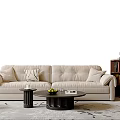 Modern Beige Living Room Sofa With Cushions And Coffee Table With Fruits Book On Rug