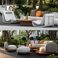 Outdoor Sofa Set With White Cushions Orange Pillows And Wooden Coffee Table In Garden