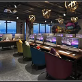 Modern Internet Cafe Interior Design With Gaming Computers Colorful Chairs Stylish Lighting And Wall Decor