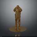 Golden Human Figure Statue With Shiny Surface On Round Base