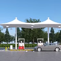 Gas Station Scene with White Canopy Fuel Pumps Car and Trees Under Blue Sky