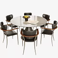Round Dining Table With Six Black Chairs Wooden Armrests Metal Legs Fruit Bowl Open Book