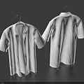 Two Plain White Shirts Hanging on Hangers Against Dark Blue Background
