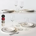 Modern Dinnerware Set with Dark Plates White Spots Wine Glasses and Tumblers on White Table