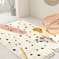 White Square Area Rug With Pink Yellow Black Spots And Fringed Edges In Modern Room