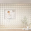 Grid Patterned Partition With Framed Center Painting Bottom Lighting And White Vase With Green Plants