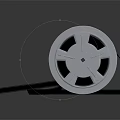Vintage Style Metallic Film Reel With Black Film Strip On Smooth Reflective Surface