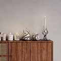 Minimalist Decorative Ornament Set on Wooden Cabinet Featuring Lit Candles and Unique Designs