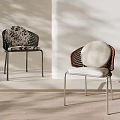 Modern Wicker Dining Chairs With Patterned And White Cushions And Metal Frames 3d model