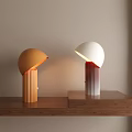 Orange And White Table Lamps With Hemispherical Shades Striped Bases On Wooden Table
