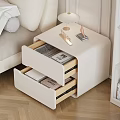 White Nightstand with Open Drawers Holding Magazines Books Topped with Lamp Decor