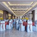 Elegant Banquet Hall with White Chairs Pink Bows Red Tables Crystal Chandeliers and Wedding Screen